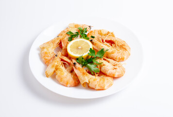 Top view of shrimps or prawns on a plate isolated on white background.