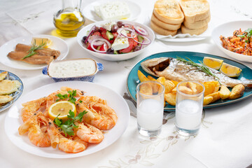 Grilled prawns or shrimps with lemon, top view. Traditional Greek tavern menu. Variety of seafood dinner. 