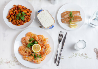 Grilled prawns or shrimps with lemon, top view. Traditional Greek tavern menu. Variety of seafood dinner.