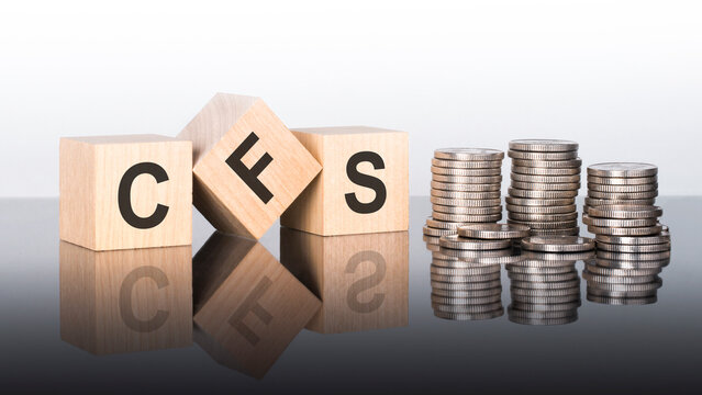cfs - text is made up of letters on wooden cubes lying on a mirror surface