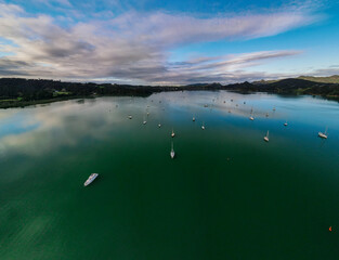 Reflective water flying over Parua Bay marina at sunset in New Zealand's Northland 