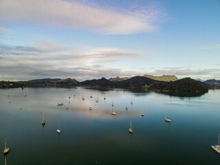 Reflective water flying over Parua Bay marina at sunset in New Zealand's Northland 