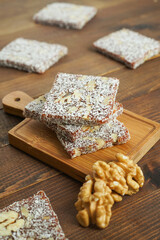Turkish delights with plenty of hazelnut, pistachio and walnut on a wooden background