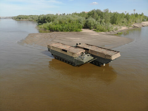 Russian military floating crawler transporters resting on the beach on their summer vacation. Heavy duty. Stop war in Ukraine. 