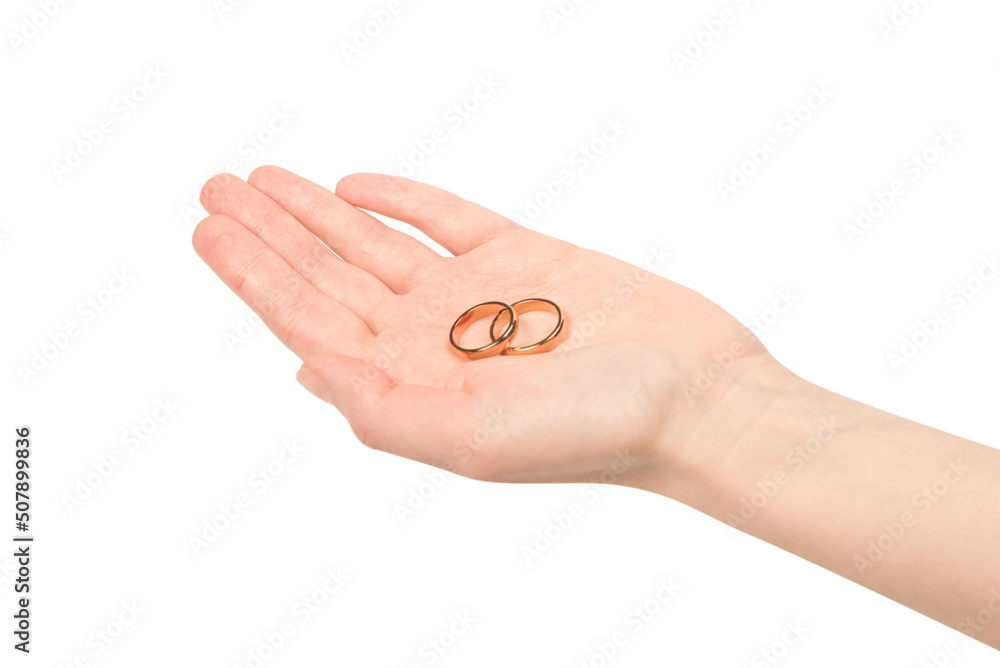 Wall mural two golden rings in a woman hand isolated on a white background.