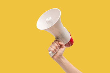 Megaphone in woman hands on a white background.