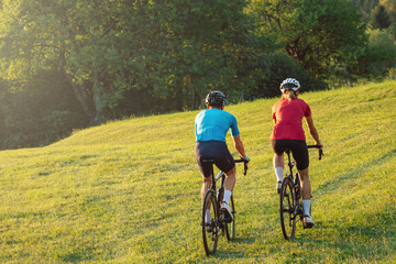 Man and woman couple cyclist during a ride on a countryside road