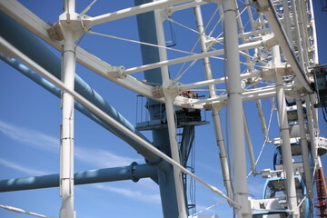 Ferris wheel. Amusement park with a big wheel for an overview of the city. Steel metal structure with cabins for people