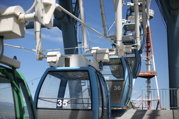 Ferris wheel. Amusement park with a big wheel for an overview of the city. Steel metal structure with cabins for people