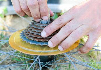 Close-up of a man adjusting a bike's gears