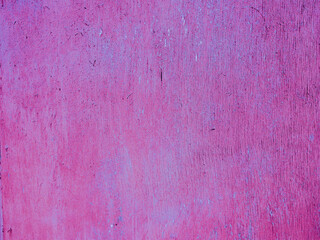 Abstract plywood texture with old magenta paint.