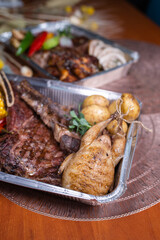 delivery of fresh grilled meat dishes in metal packaging