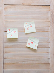 Wooden wall made of slats, stickers on the wall with the text "remember" and the symbol of heart, valentine's day.