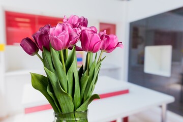 A bouquet of flowers on a table. In the background, the interior of a kitchen. The concept of home comfort.