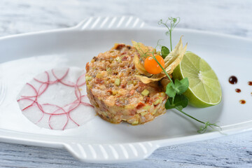 shrimp and salmon tartare with avocado, lemon, sprouts and lime
