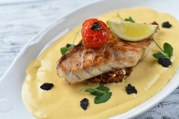 grilled fish fillet with vegetable puree, tomatoes and lemon
