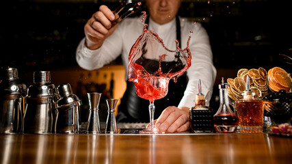 magnificent view on bar counter with a variety of bar equipment and goblet with splashing cold drink
