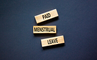 Paid menstrual leave symbol. Concept words Paid menstrual leave on wooden blocks. Beautiful black...