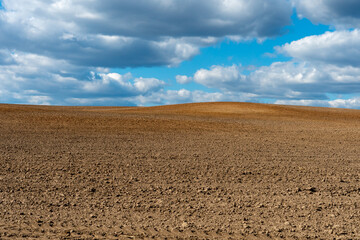 Rows of soil before planting. Drawing of furrows on a plowed field prepared for spring sowing of...