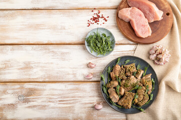 Stewed turkey fillet with sprouts of green peas on white wooden background. top view, copy space.