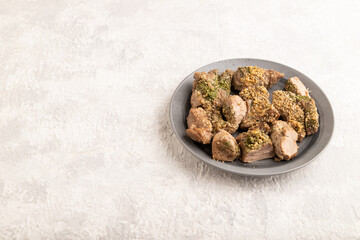 Stewed turkey fillet with garlic on gray concrete background. side view, copy space.