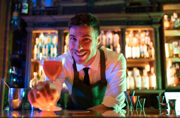 very happy barkeeper serving drink