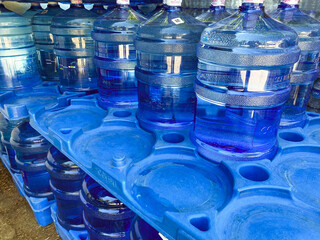 water in large bottles. many containers with purified water. environmental care. extraction and processing of natural resources