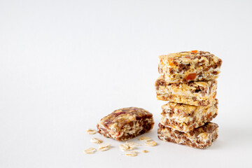 fitness candy and oatmeal scattering on white background, copy space