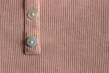 knitted pale pink cotton synthetic fabric in ribbed with buttons for sewing children's and adult clothing