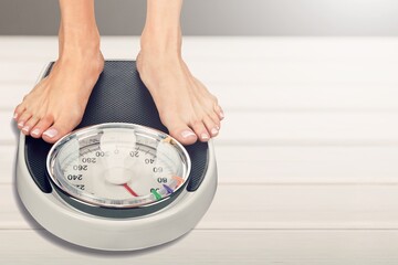 obesity and overweight, overweight woman feet on the scale, obesity and bad habits concept.