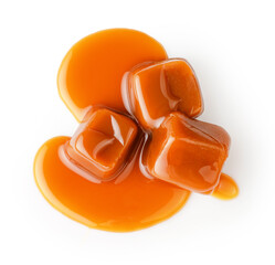 Top view of caramel cubes with caramel sauce isolated on white background.