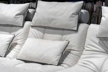 Fototapeta premium Empty cozy white leather sofa with pillows at hotel