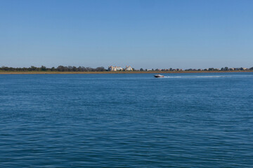 Obraz premium Isla Canela in Spain from Vila Real de Santo Antonio in Portugal, near the mouth of the Guadiana River in the sea 
