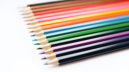 A set of colored pencils isolated on a white background in banner format. Place for text