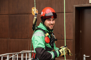 Portrait industrial mountaineering worker in uniform on roof