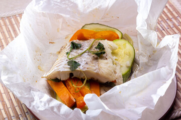 White fish fillet with vegetables in rustic style. Healthy eating: cooked fish fillet with...