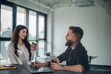 Fototapeta premium Two business colleagues having a meeting in the open space office