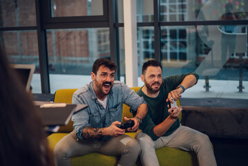 Work colleagues playing video games during their work break