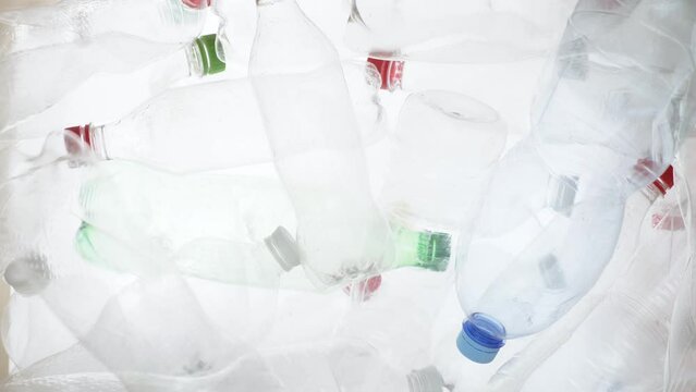 Empty plastic bottles falling down. Water PET bottle recycling plastic water bottle recyclable waste sorting. Recyclable trash recycle garbage bottles background plastic PET recycling waste processing