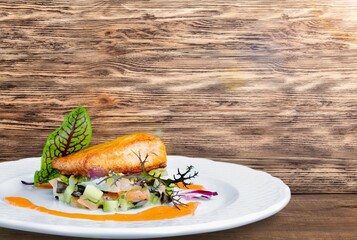 fried fish fillets on a plate on a wooden table