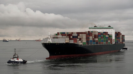 Port of Rotterdam, the Netherlands - 10 20 2021: Large container vessel entering the port with the...