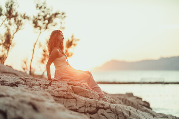 Fototapeta na wymiar Woman Enjoying Sunset At The Beach