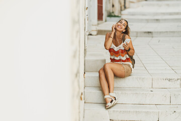 Woman Enjoying Music On A Summer Vacation In Mediterranean City