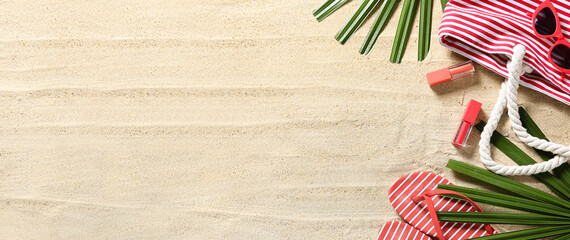 Set of beach accessories and tropical leaves on sand. Banner for design