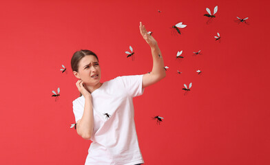 Young woman and many mosquitoes on red background