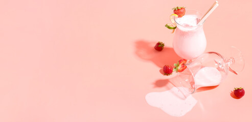 Glasses of strawberry Pina Colada cocktail on pink background with space for text