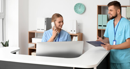 Male doctor near reception desk in clinic