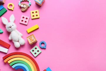 Colorful children toys on pink background
