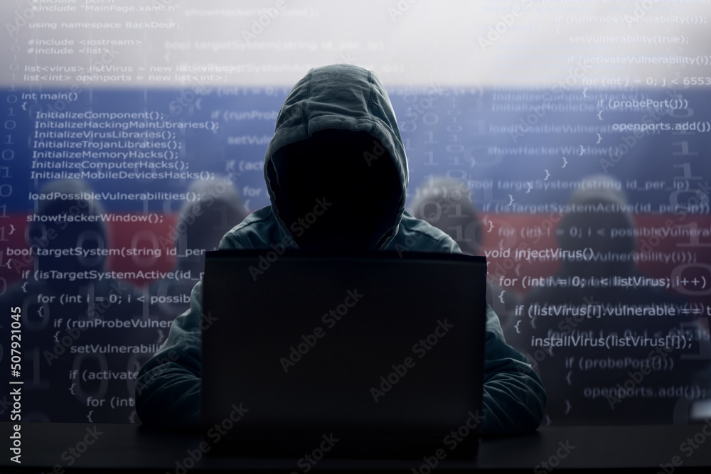 Wall mural Russian hacker at laptop. Malware and virus.