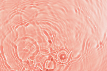 Texture of water with ripples on pink background, closeup